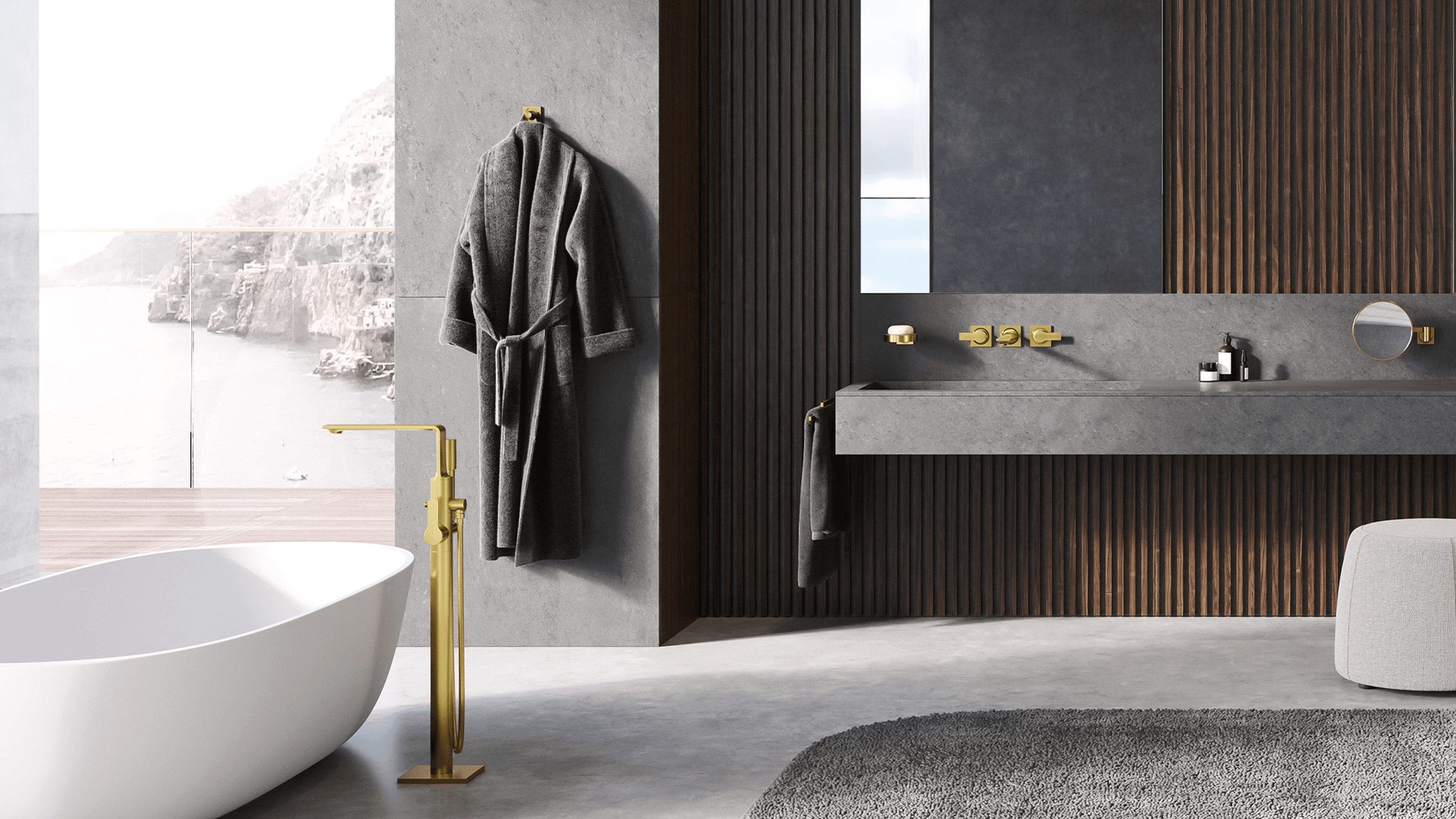 Luxury bathroom with freestanding white bathtub, brushed gold floor-mounted faucet, dark wood slat walls, and concrete floating vanity with ocean view