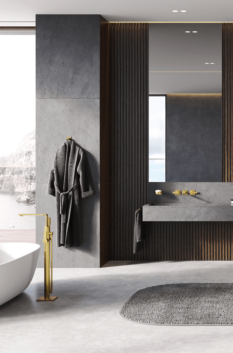 Luxury bathroom detail with brushed gold floor-mounted faucet, dark wood slat accent wall, and concrete floating vanity with ocean view