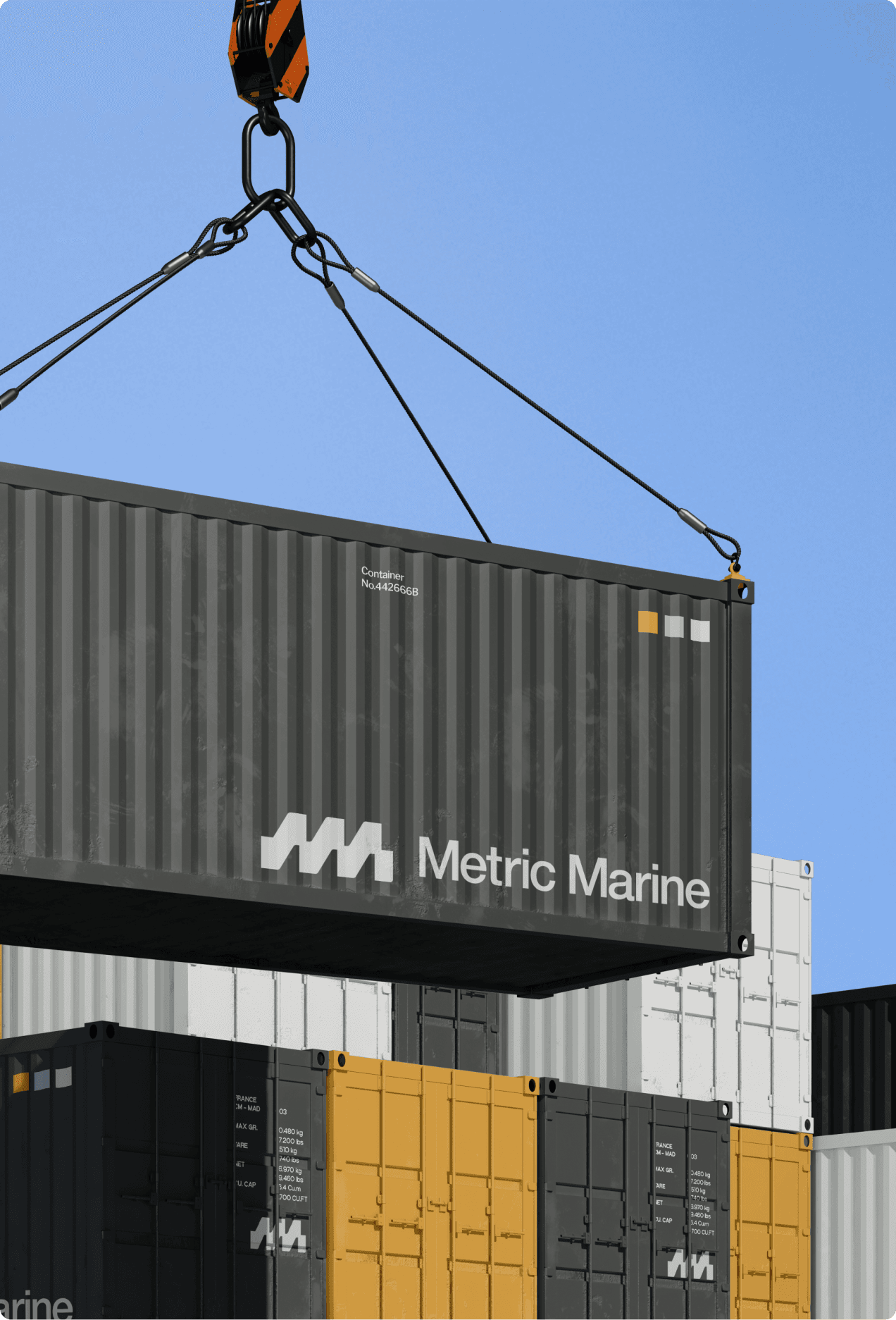 Metric Marine branded shipping container being lifted by crane over a stack of containers at a marine port