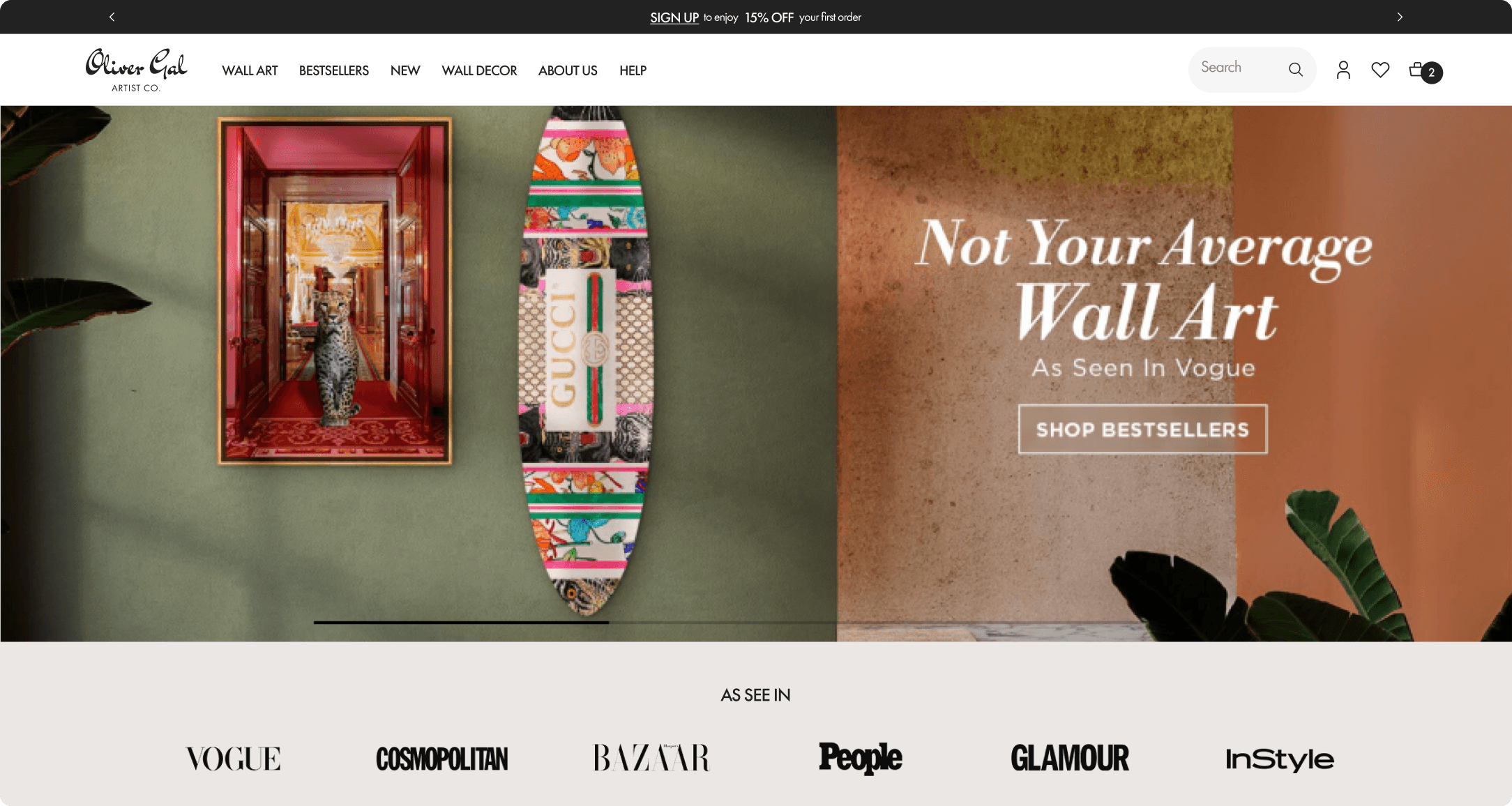 Oliver Gal homepage hero with the Not Your Average Wall Art headline, framed art, and a decorative surfboard as seen in Vogue